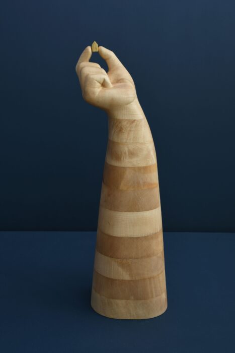 Wooden sculpture handcrafted art hand and house